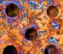The Surface Of Rusty Iron With Drilled Holes For Bolts. Ultra Macro Background