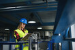 © Halfpoint - Portrait of female engineer working in industrial factory, doing checkup control.