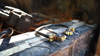 Wall Mural - Old battery terminals and connections. Close-up of the contacts of a battery or a powerful rechargeable electrolyte canister of a heavy machine. Selective focus