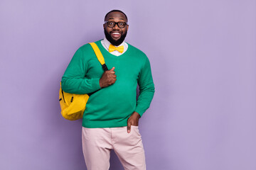 Poster - Photo of cheerful nice person put hand pocket carry backpack isolated on violet color background