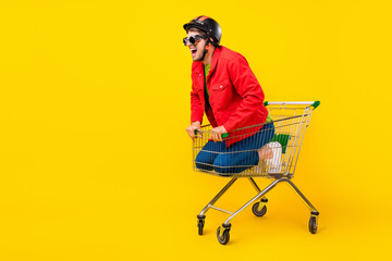 Poster - Full length body size view of attractive cheery guy inside cart having fun copy space isolated on bright yellow color background