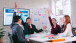 © ronnarong - Asian business team celebrating success together in boardroom.