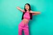 Leinwandbild Motiv Photo of adorable female in trendy set of clothes feel free dancing in club isolated on teal color background