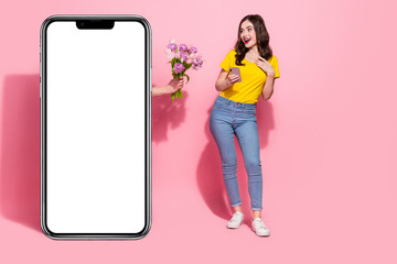 Full length photo of amazed girl look empty space secret admirer fresh flowers isolated on pink color background