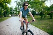 © VIAR PRO studio - Cyclist riding in a city park.