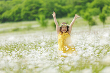 Happy Girl In The Field With Flowers. High Quality Photo