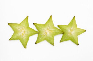 Raw carambolas or Star fruit slices on white background.