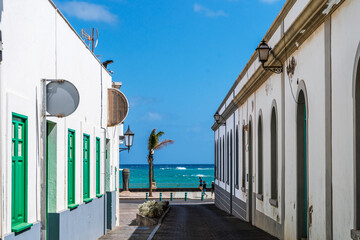 Wall Mural - Traditional street with whitewashed houses and colorful windows and doors in Arrecife, Lanzarote, Canary Islands, Spain