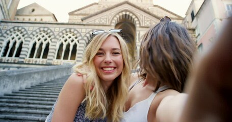 Wall Mural - Two cheerful young women taking selfies together. Two women making funny expressions while taking selfies