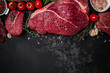 Beef tenderloin fillet with rosemary and spices on a dark background. Preparing fresh beef steak ready to cook, Long banner format. top view