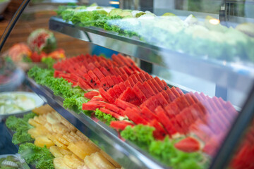 Wall Mural - Photo of the fresh fruit in the freezer at hotel lounge restaurant canteen events. Pieces of Red watermelon, yellow pineapple, green guava are in freezer. Food festival catering celebrate party Ideas