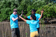 © noon@photo - Group of  friendly volunteers with blue-shirted  are Mangrove forest planting in the countryside,they are happy.Natural environment conservation concept