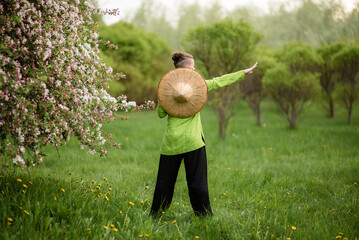 Asian woman train with tai chi in the park in the evening, chinese martial arts, healthy life care concept.