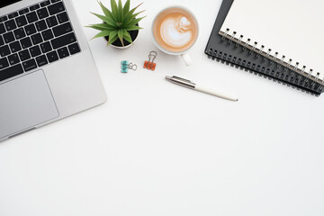 Wall Mural - Flat lay, Business office and education concept on white table desk background with laptop computer and coffee cup, blank notepad and stationary,Top view with copy space