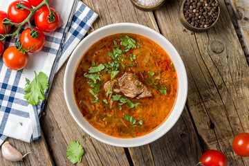 Wall Mural - soup kharcho with meat on bowl top view on wooden table