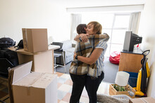 Happy Mother Hugging Daughter Moving Into College Dorm Room