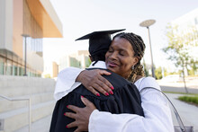 Proud Mother Hugging College Graduate Son