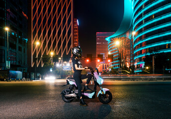 Cool girl travel in electric bicycle at night