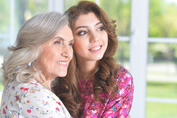 Sticker - grandmother and granddaughter posing beautifully at home