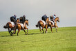 Thoroughbred Racehorses exercising at gallop on the heath at Newmarket