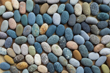Colored Blue And Yellow Sea Stones Background. Top View