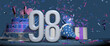 Solid white number 98 in the foreground, birthday cake decorated with candies, gifts and party hat with confetti ejecting bugles, against dark blue background. 3D Illustration