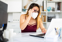 ..Portrait Of Female Worker In Disposable Face Mask Engaged In Business Activities At Workplace In Office, New Normal Due To Coronavirus Outbreak