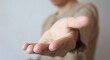 © SURASIT - Opened hand giving some help. Young man offering helping hand. Banner with gesture photo