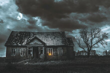 Old Wooden House,dramatic Clouds At Night. Abandoned Haunted Horror House.Near Is One Tree At Night With A Moon.
