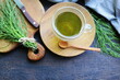 Fresh horsetail plant on a table with herbal tea on the wooden background