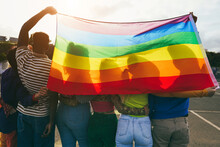 Young Diverse People Having Fun Holding Lgbt Rainbow Flag Outdoor - Main Focus On African Guy Back