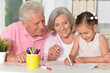 © aletia2011 - Portrait of little cute girl with grandparents drawing at the table