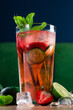 Fresh strawberry mojito drinks on a vintage wooden dark table. mocktail decorated with strawberries and mint