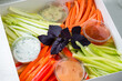 catering box with fresh vegetables - carrot, cucumber, pepper and celery sticks