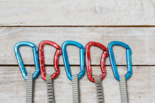 Set Of Climbing Quickdraws On A Wooden Background