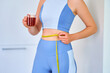 © Goffkein - Fitness sportive healthy woman drinking herbal tea for weight loss and slimness body