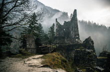 Castle Ruins With Fog And Mist In The Hills