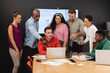 © Wavebreak Media - Businessman discussing business strategy to multiracial colleagues over laptop in meeting at office