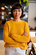 © Wavebreak Media - Portrait of confident biracial young businesswoman standing with arms crossed in office