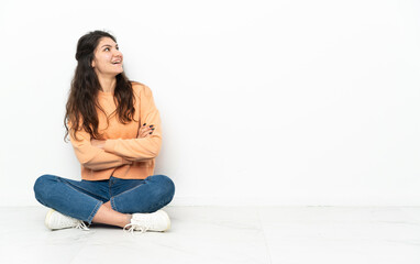 Wall Mural - Teenager Russian girl sitting on the floor looking to the side