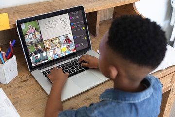 Poster - African american boy typing message on laptop during video call while learning in online class