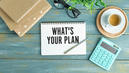 Selective focus.What's your plan in white word with pen,glasses,paper clips,notebook and calculator with white background.Business and finance concept