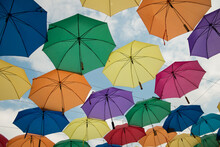 Colorful Umbrellas Background Hanging In Blue Sky
