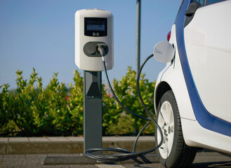 Wall Mural - Close-up photo of an electric car charging at a charging station