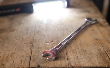 Fixed wrench and lantern on a wooden prank