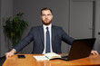 © millaf - Serious pensive thoughtful focused young businessman in office with laptop