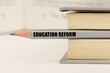 In the book between the pages lies a pencil with the inscription - Education Reform