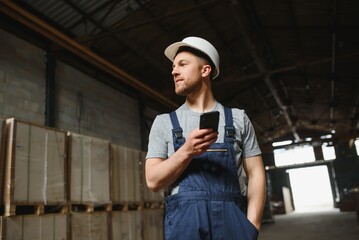 Wall Mural - Management team, engineer, or foreman. Standing checking job information about industrial production management within the factory by phone. Teamwork concept