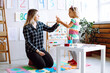 © Татьяна Волкова - Little girl and educator holding hands, talking and playing in playroom. Interesting logic and intelligence game for kindergartners. Communication and development of mental abilities in kids