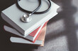 © PaeGAG - Medical student textbooks with pen and stethoscope on table. medical education medicine books and notes on the table.